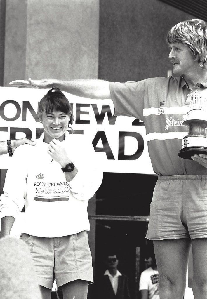 Sir Peter Blake holds his arm above Tracy's head, showing show short she is. Black and white photo from 1990